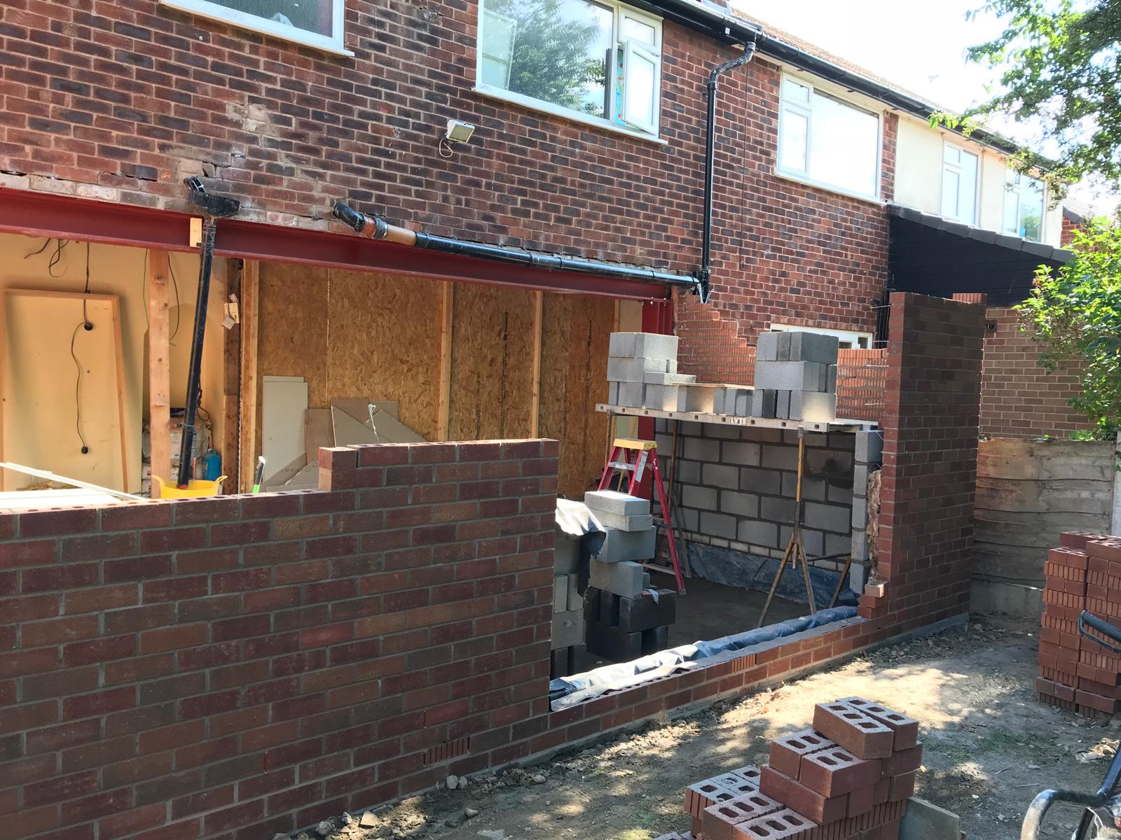 Romiley extension under construction with brickwork and a steel beam