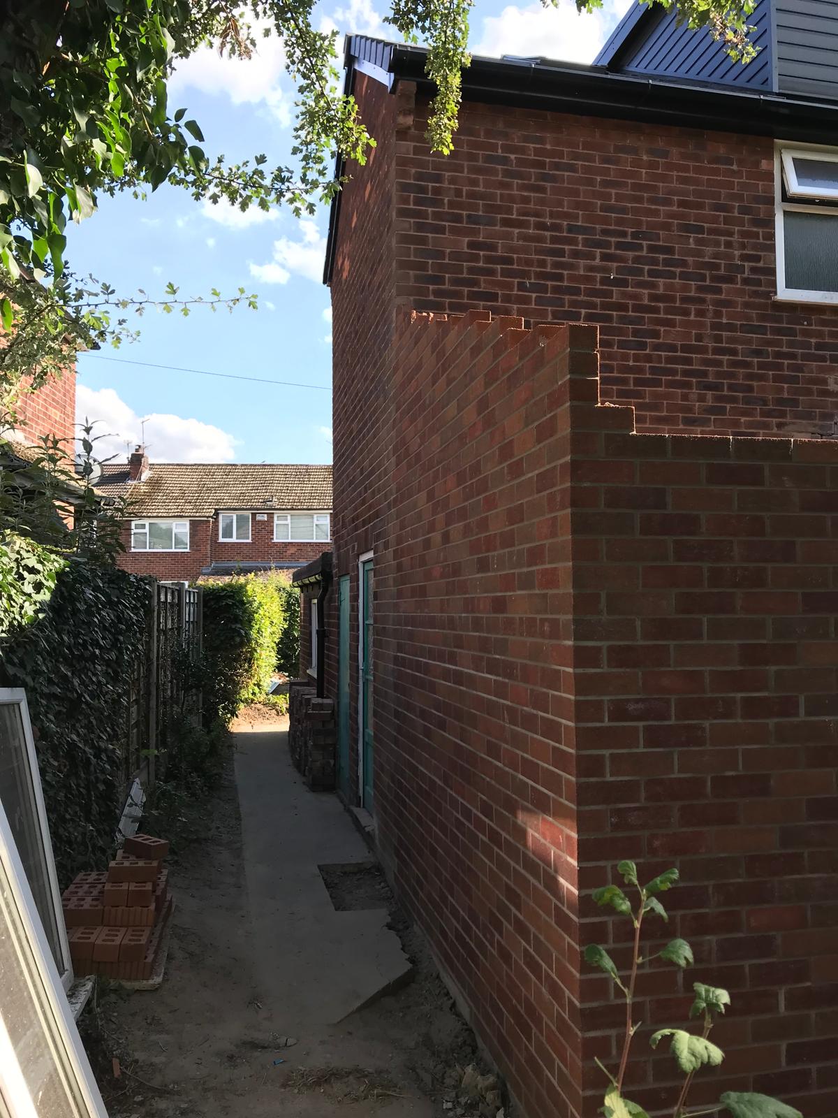 Side brick wall during construction of the Romiley extension