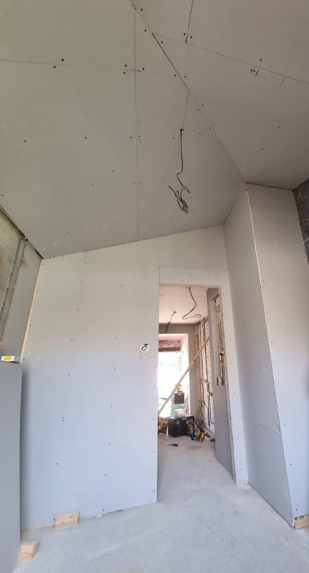 Plasterboard interior with exposed wiring
