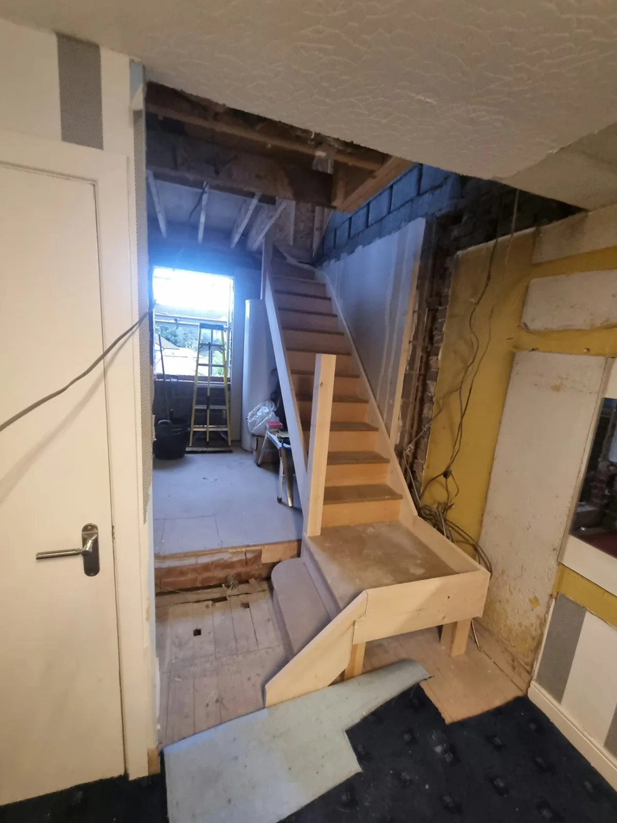 New timber loft staircase being installed at the Prestwich project