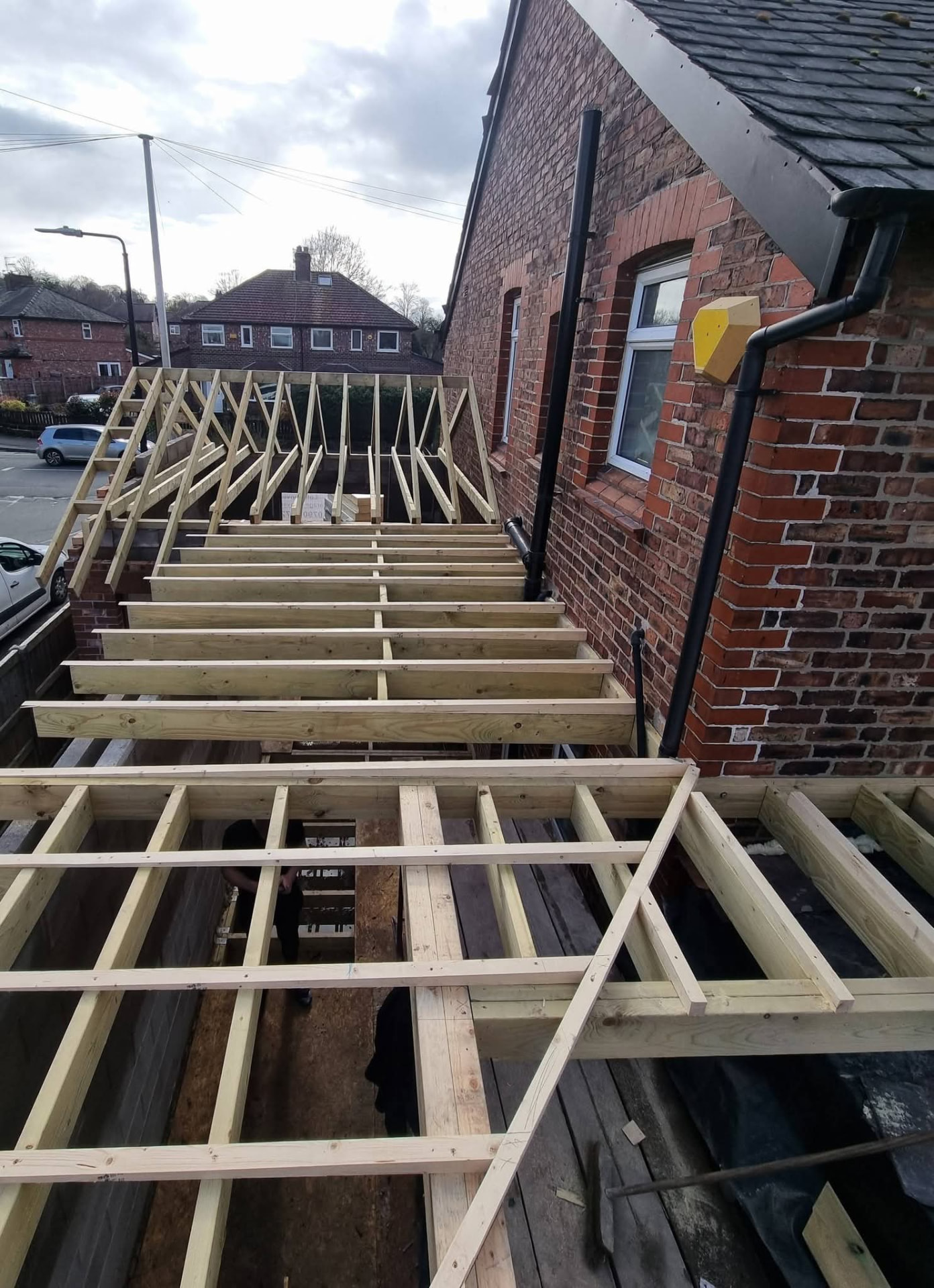 Integrated pitched and flat timber roof framing at the Trafford wraparound extension