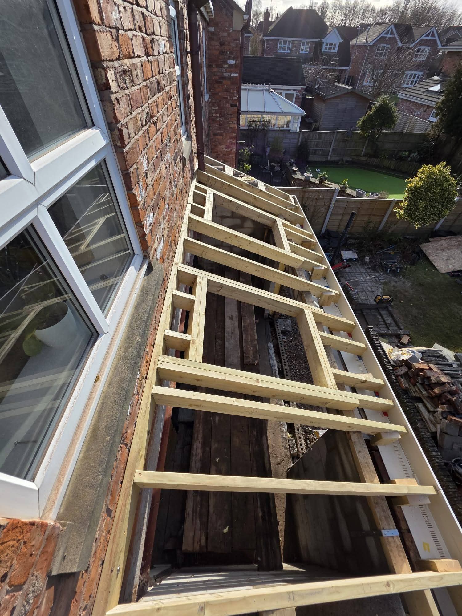 Lean-to roof framework viewed from above with two roof window openings and white fascia
