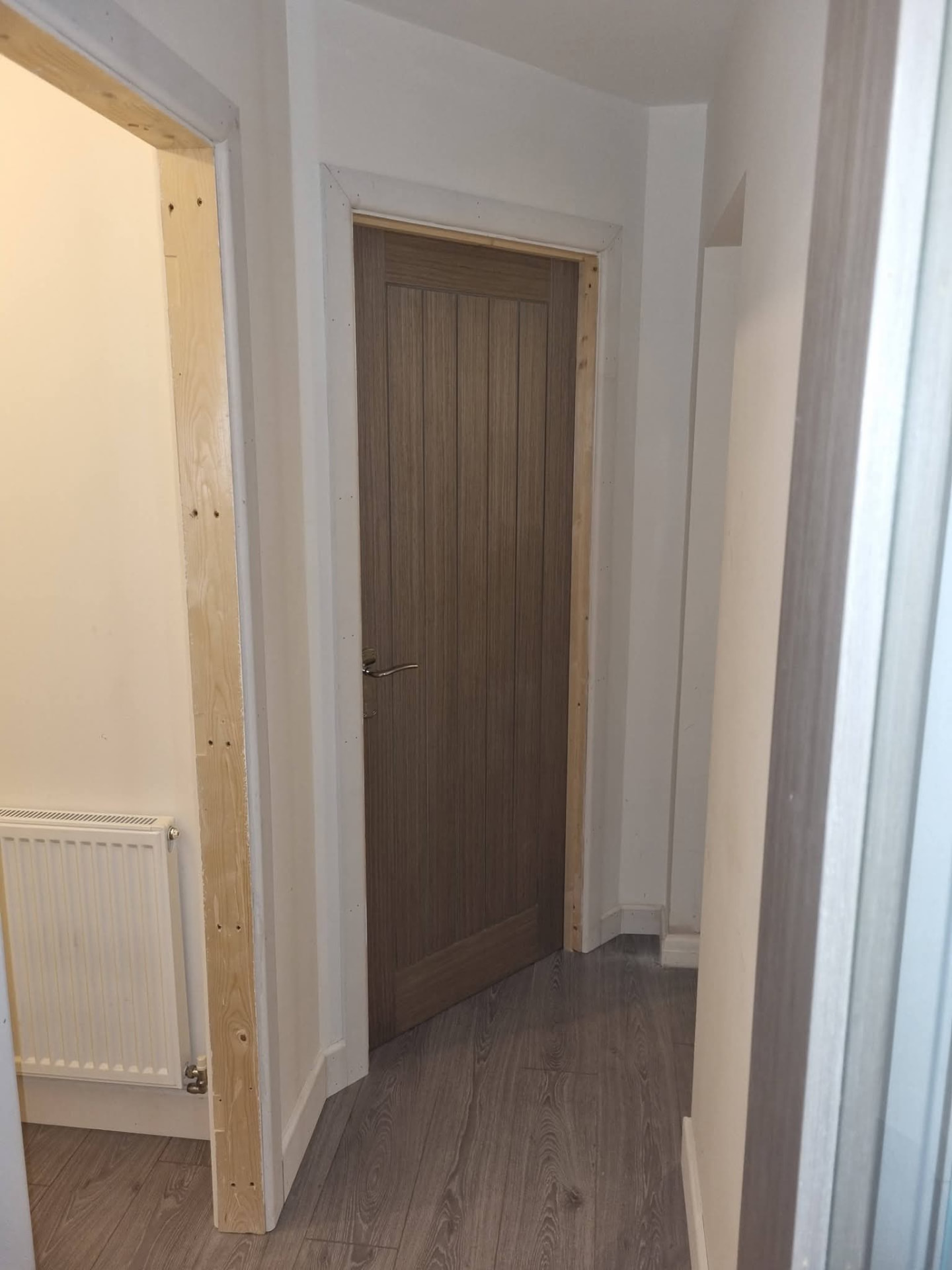 Finished hallway with timber door and new flooring