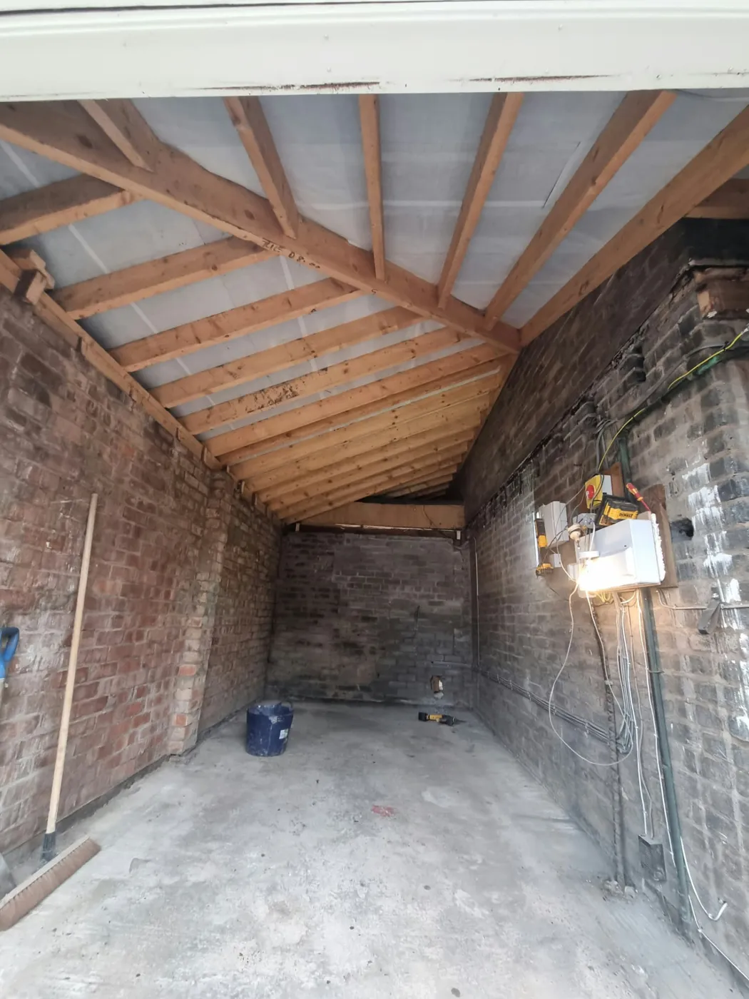 Structural work in the Marple garage, with new pitched roof timbers above the prepared floor