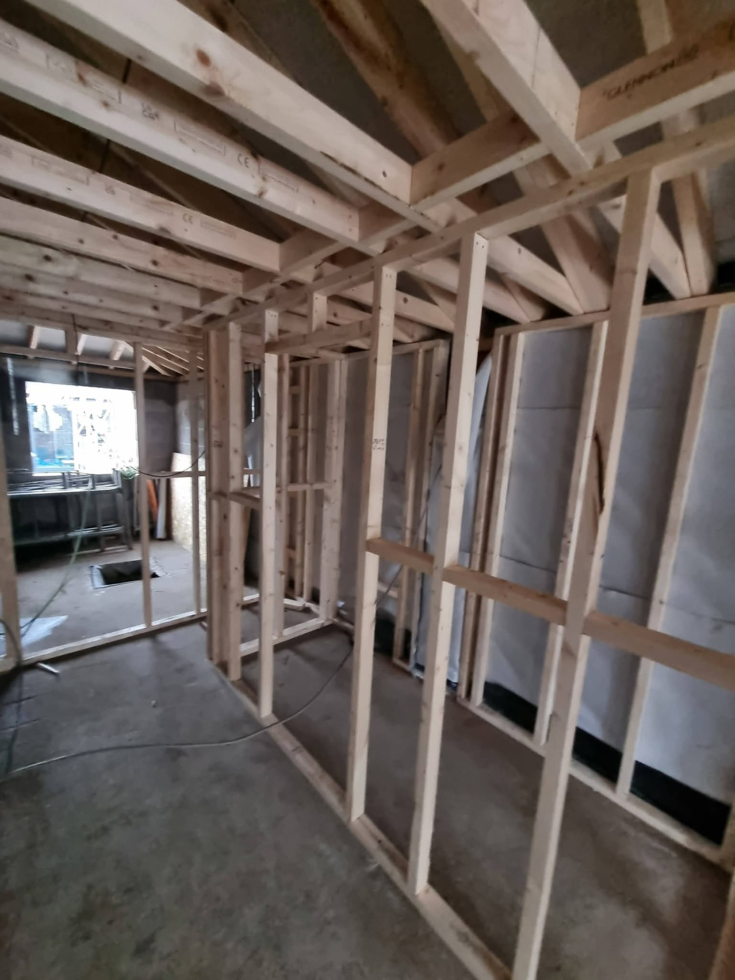 Timber stud partitions and exposed ceiling joists during extension construction