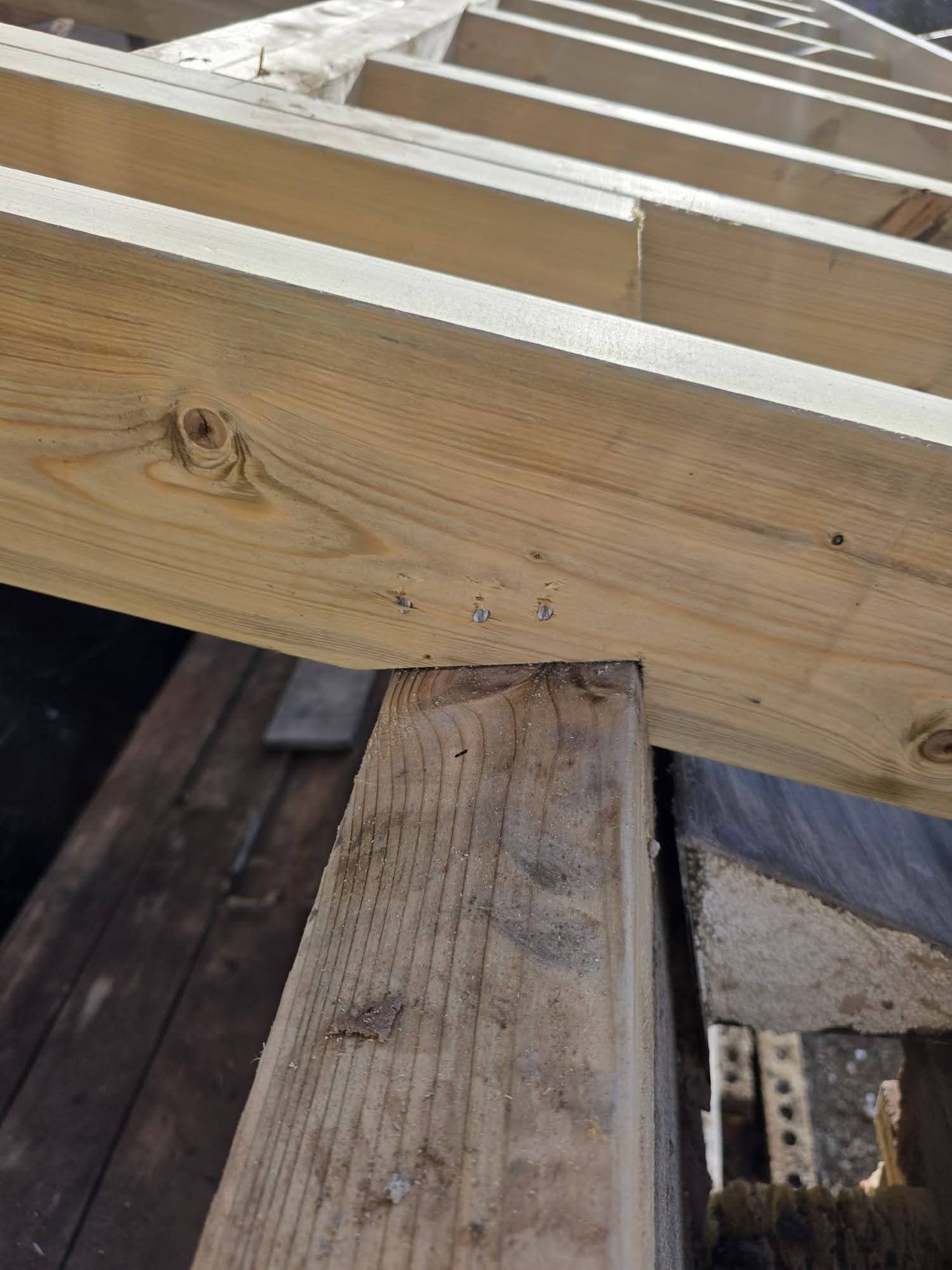 Close-up of a timber rafter connection above an existing timber beam