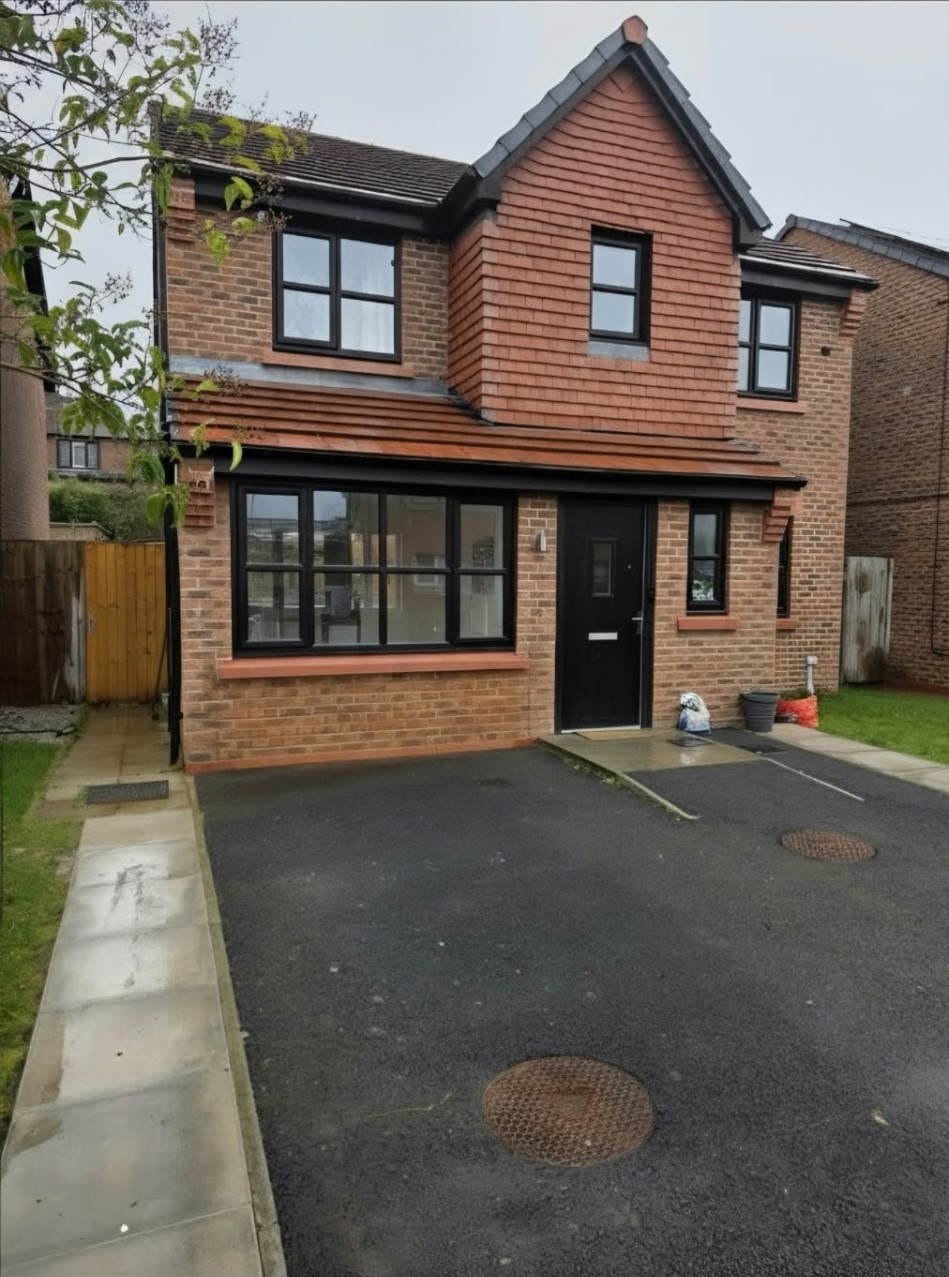 Finished Worsley home office exterior with new window and brickwork replacing the garage door