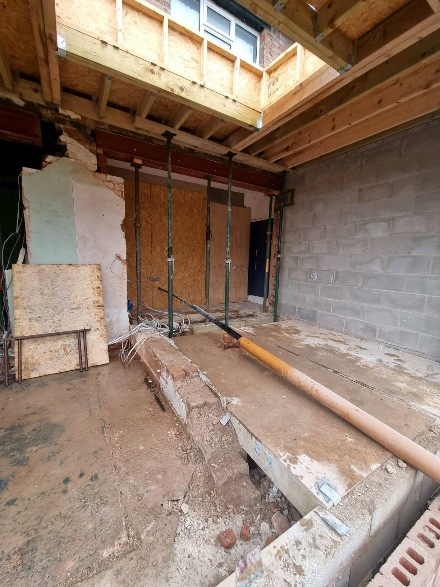 Structural opening with temporary props, exposed beam and block walls